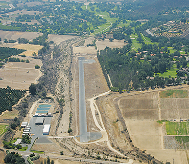 <span>1966</span> 
The airfield was built and dedicated in 1966. The original runway was 2500 feet long and 50 feet wide and was constructed to parallel the main channel of the San Luis Rey River.